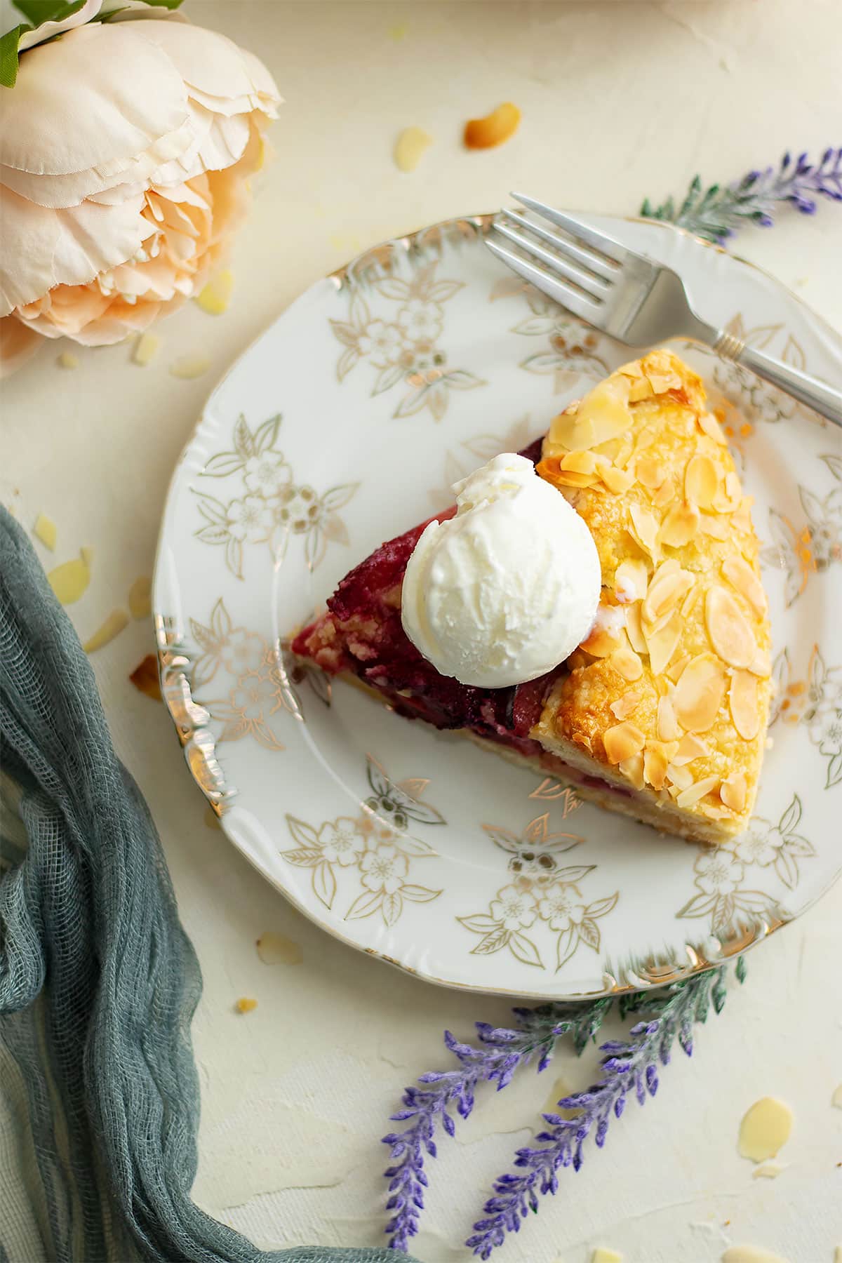 A slice of plum galette with scoop of ice cream.