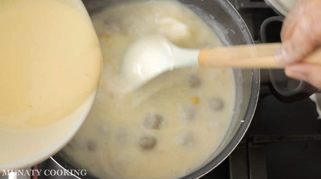 Adding yogurt mixture to the soup.
