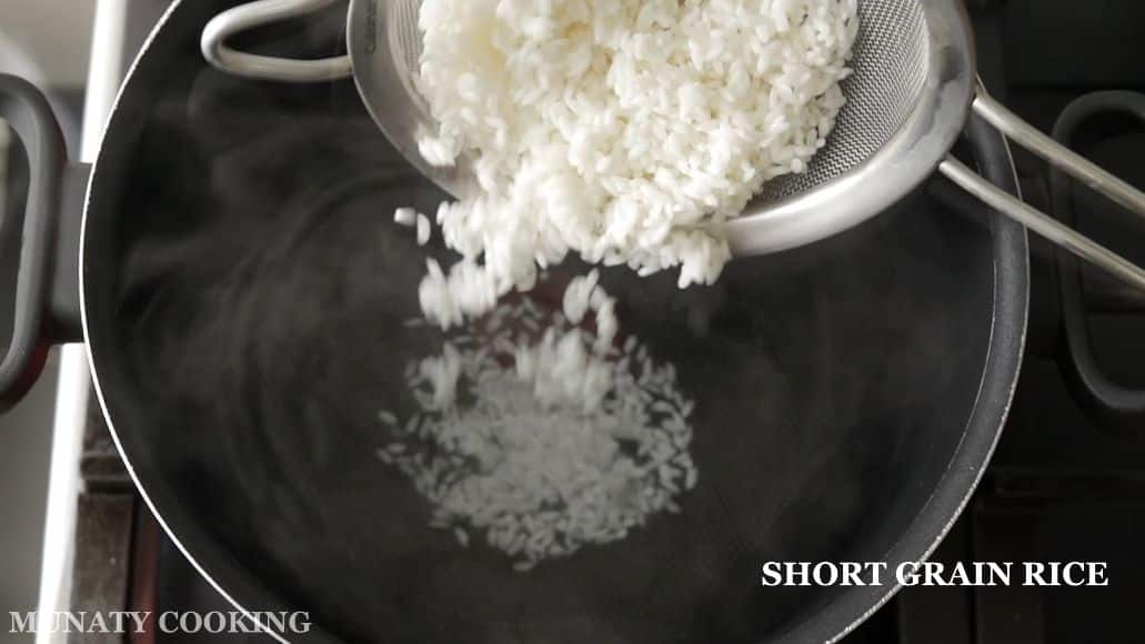 Cooking the rice in water.