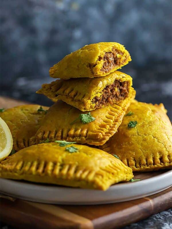 Jamaican pattiy cut in half showing juicy beef filling.