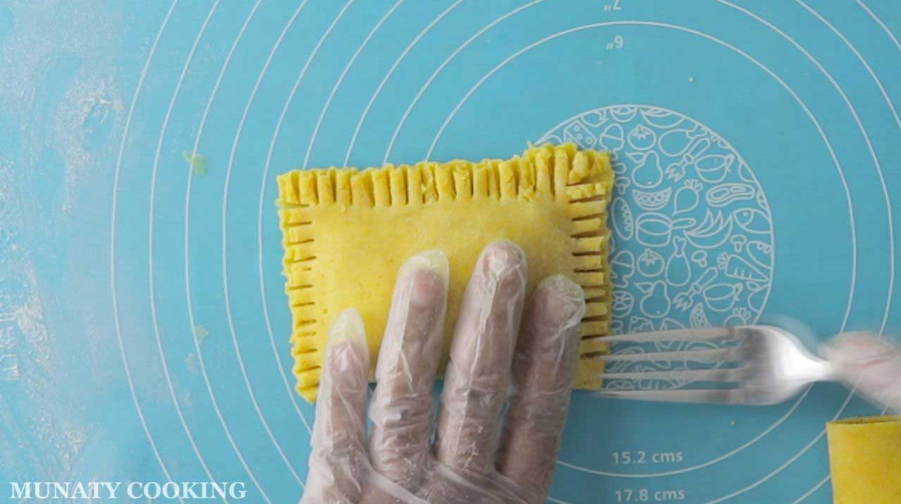Crimping the edges with a fork.