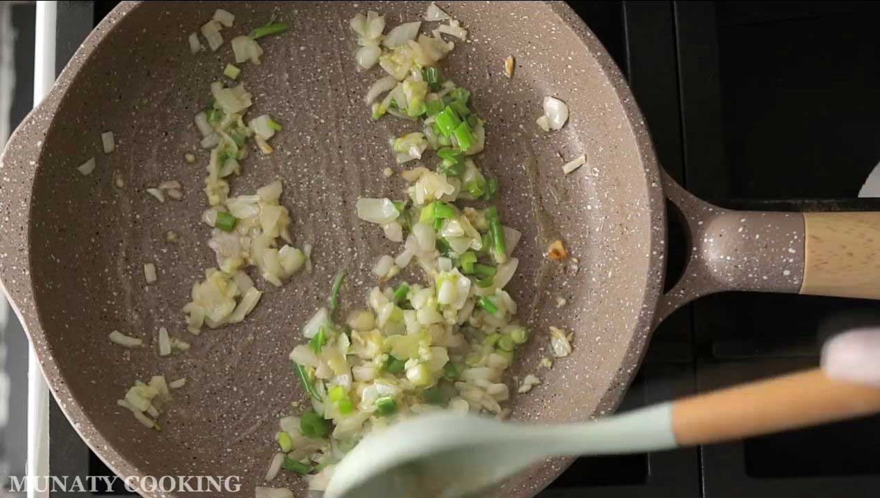 frying onion and garlic in a pan.