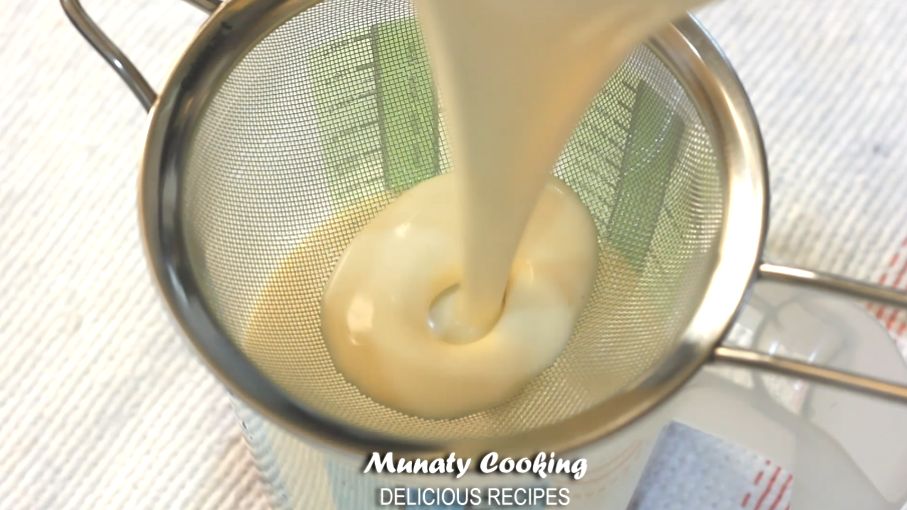 Straining the creme mixture through a strainer.