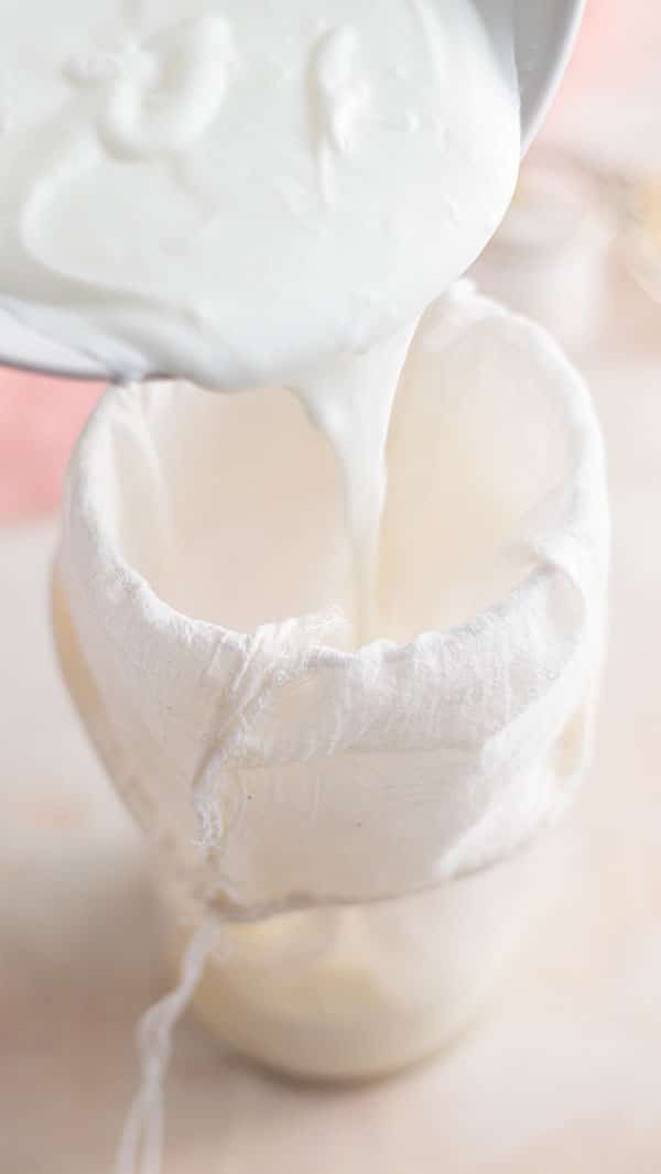 Pouring the yogurt in the cheese cloth strainer to make labneh.