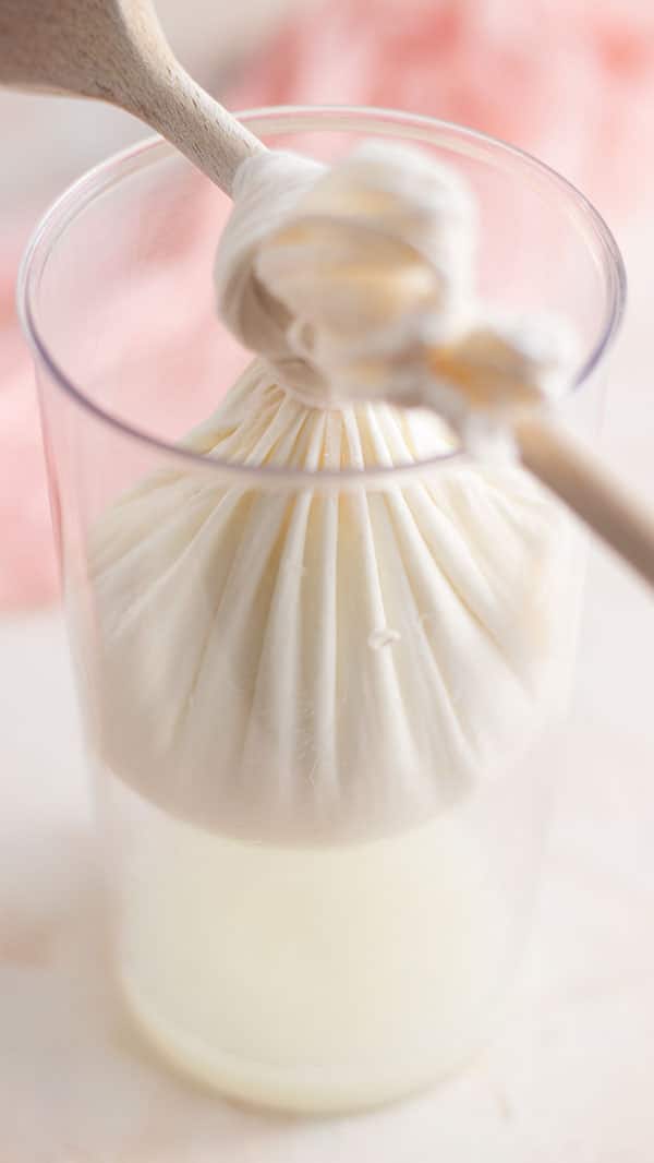 Small amount of whey coming out of the yogurt in the process of making labneh at home.