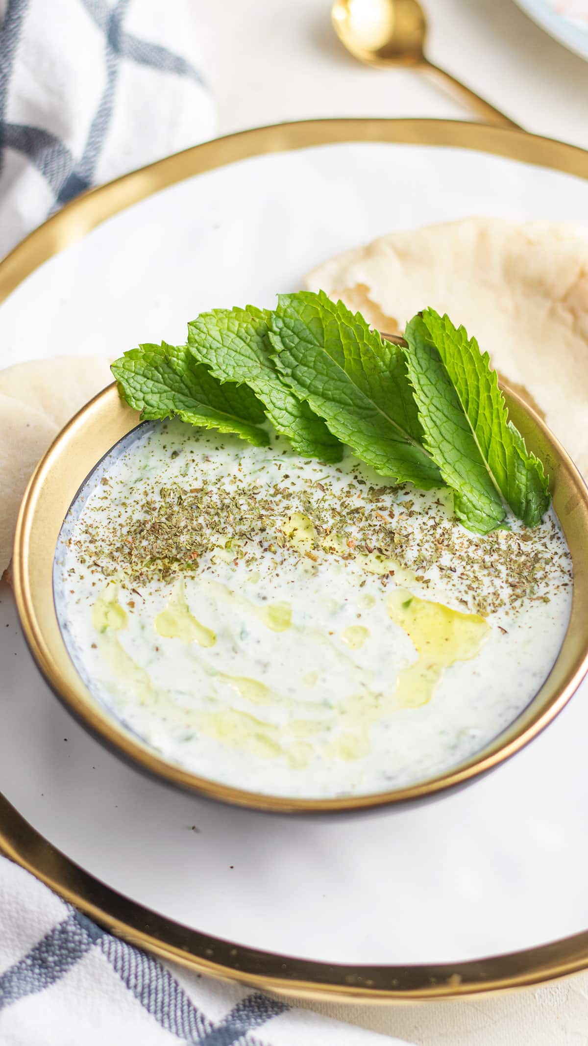 cucumber yogurt salad, in a white bowl.