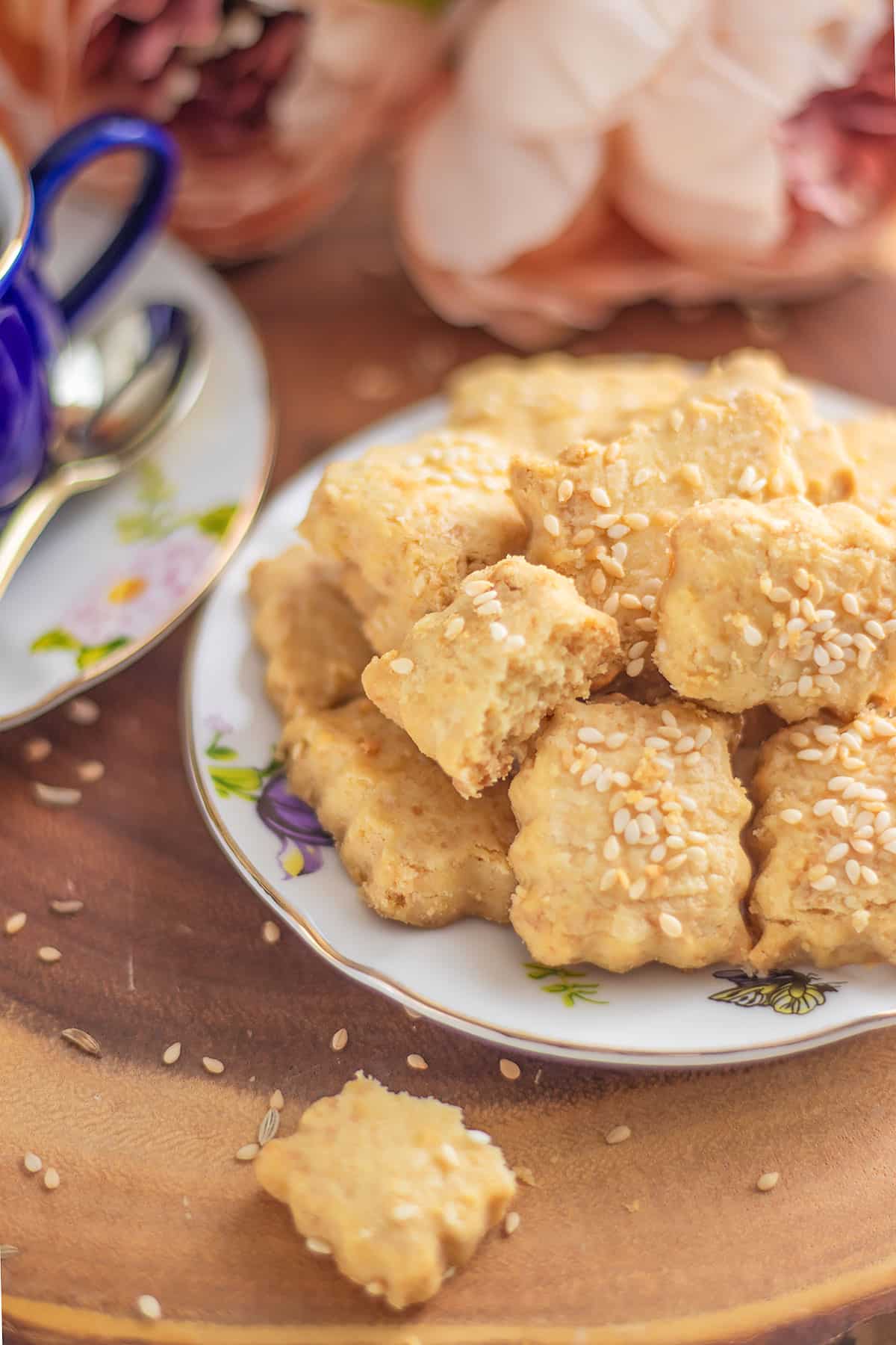 Close up image of savory cookies in a small plate garnished with sesame seeds.